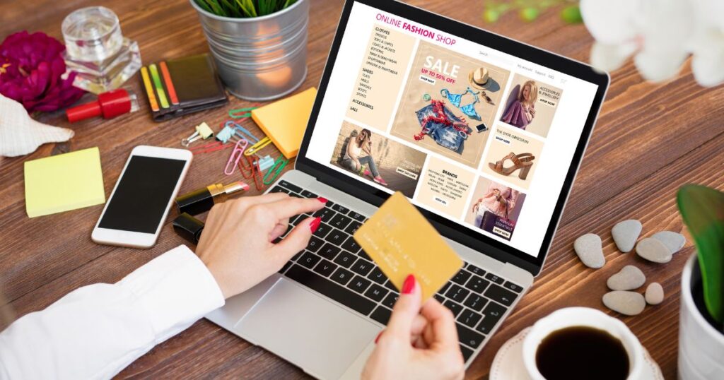 A woman shopping online, holding a credit card 