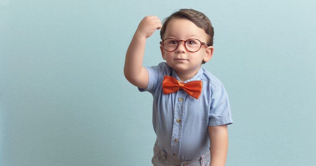 Nerd kid showing muscles