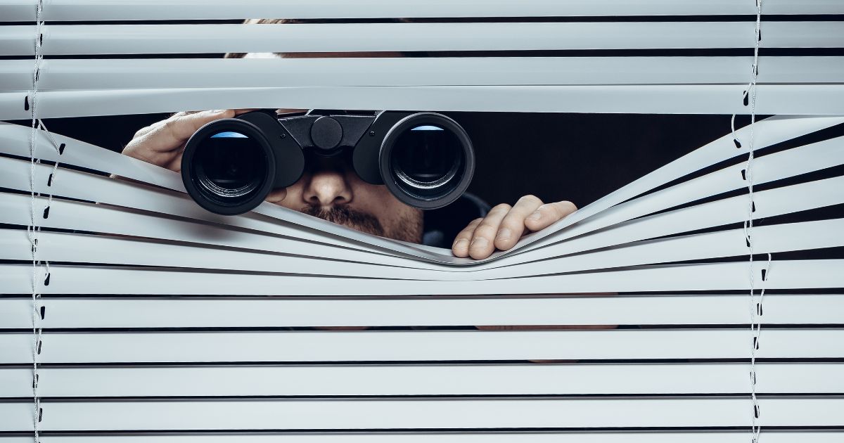 Looking through the shades with binoculars, spy, competitor analysis