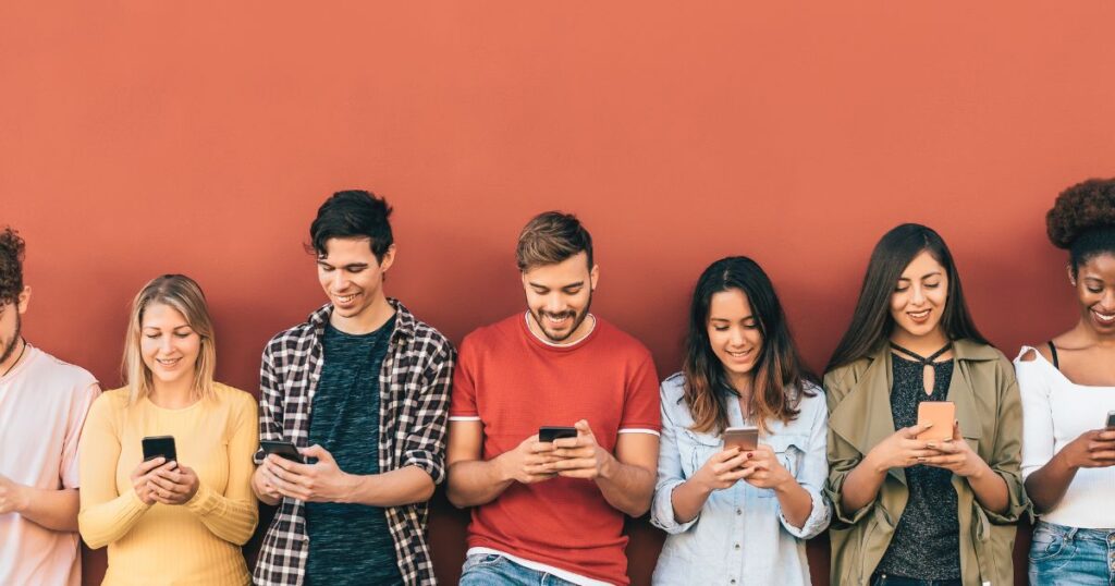 Young people looking at their smartphones