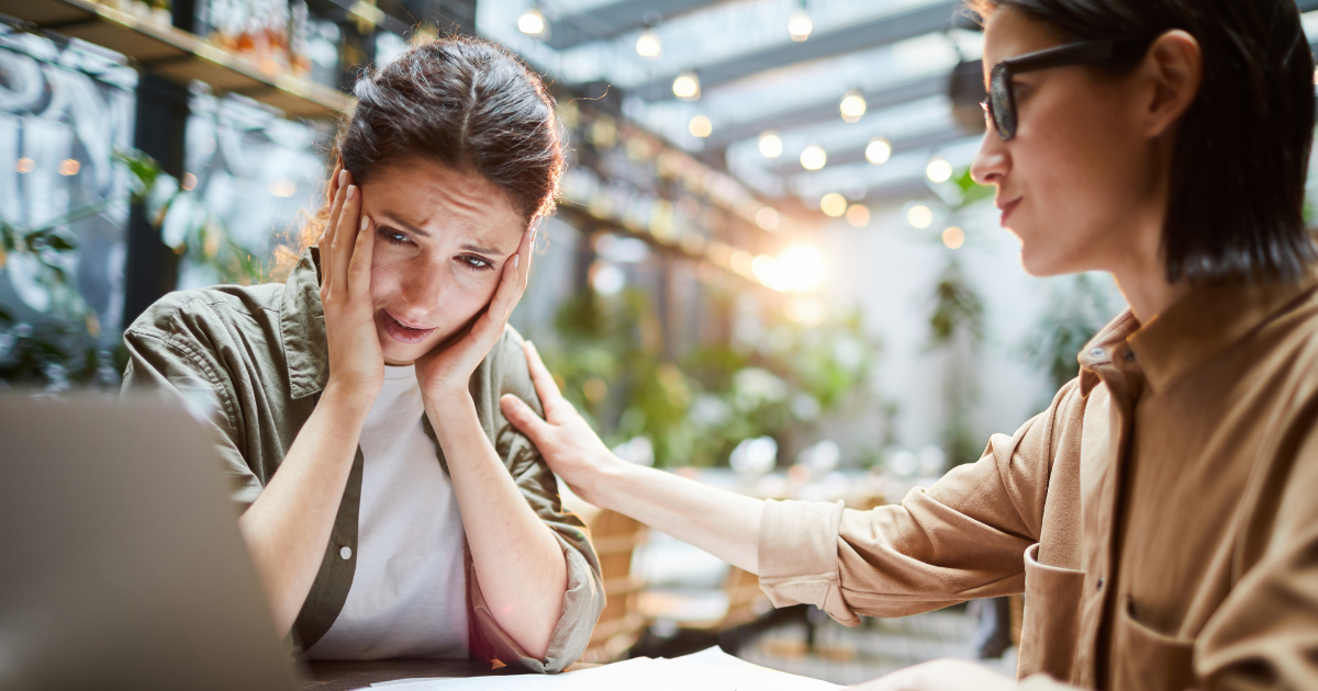 2 women with a laptopm looking disappointed.